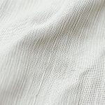 Close-up detail of the soft bamboo wrap top and flare leggings fabric texture and stitching.