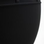 Close-up of black cotton leggings fabric, 3/4 length with pockets, showing soft texture and quality stitching.