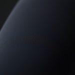 Close-up of high-waisted black yoga pants showing fabric texture and stitching detail for women.