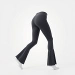 Flare active pants in charcoal grey, hyperrealistic studio photo on white background.