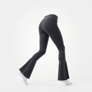 Flare active pants in charcoal grey, hyperrealistic studio photo on white background.