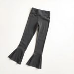 Flat lay of charcoal grey flared leggings, flare active pants neatly folded on a neutral surface.