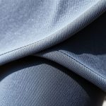 Close-up detail of the fabric texture and stitching on our fold over flare leggings.