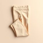 Beige fold over flare leggings in a flat lay on a clean, neutral surface.
