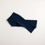 Flat lay of Navy Blue flare yoga pants, neatly folded on a clean, neutral surface.