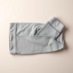 Flat lay of Heather Grey high rise leggings with pockets | 3 4 leggings neatly folded on a neutral surface.