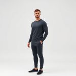 Male yoga outfit in charcoal, mens yoga wear on white background, hyperrealistic studio photo.