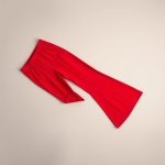Red wide leg yoga pants Australia flare leggings for short legs, neatly folded on a neutral surface, top-down view.