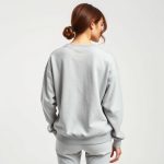 Back view of a model wearing the wrap top australia organic cotton sweatshirt in Heather Grey.