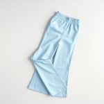 Sky Blue yoga flare pants neatly folded, wide leg workout pants in minimalist flat lay.