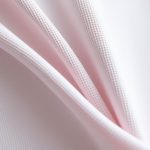Close-up of high-quality fabric and stitching on yoga tank tops female yoga pants, showcasing texture and material detail.